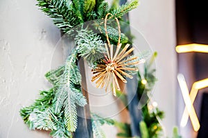 A Christmas toy in the form of a star hangs on the tree. Handmade