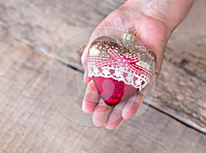 Christmas toy in the hands of a grandmother, an elderly man. New Year. Christmas. Wooden Background