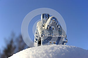 Christmas toy house on the snowdrift