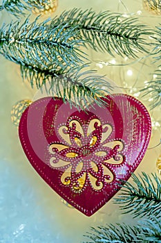 Christmas toy red heart with ornament Toned image. Copy space. Closeup. Happy Merry Christmas and New year.