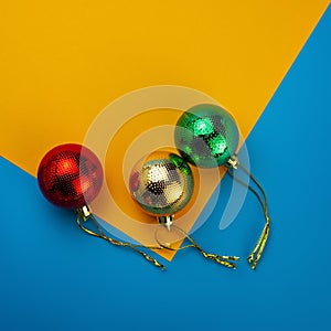 Christmas toys balls on a yellow and blue background