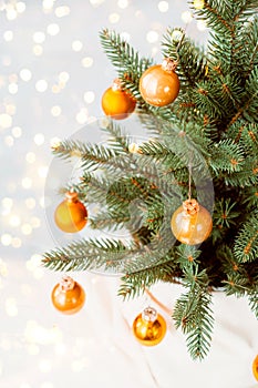 Christmas toys on a branch of a Christmas tree on a light background. round Christmas balls on a small fir tree with