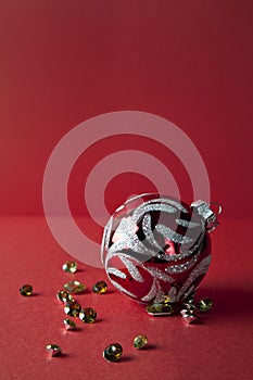 Christmas toys and diamonds on red background