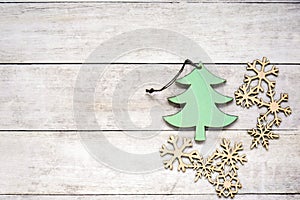 Christmas toys green fur-tree and snowflakes on old wooden background. Winter concept, new year decorations. Flat lay