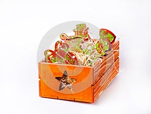 Christmas toys in wooden crate on a white