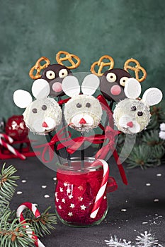 Christmas treats - cake pops Rabbits and Santa reindeers from cookies in chocolate, coconut flakes, marshmallows and