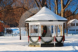 A Christmas tree adorns a village square