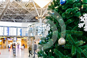 Christmas tree in the airport and Flight schedule information board