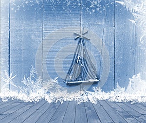 Christmas tree arranged from sticks on empty wooden deck table on sparkly blue background. Ready for product display montage