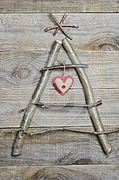 Christmas tree arranged from sticks, twigs, driftwood on wooden