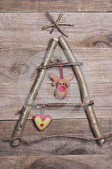 Christmas tree arranged from sticks, twigs, driftwood on wooden