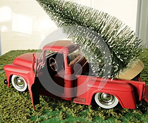 Christmas tree in back of red pick up truck