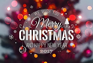 Christmas tree background and Christmas decorations with blurred, sparking, glowing and text Merry Christmas and Happy New Year