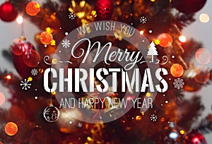 Christmas tree background and Christmas decorations with blurred, sparking, glowing and text Merry Christmas and Happy New Year.