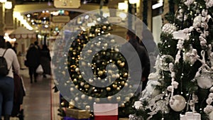 Christmas tree background and Christmas decorations in the mall. White silver balls on green fur. Happy New Year theme