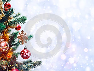 Christmas tree background and Christmas decorations with snow, blurred, sparking, glowing.