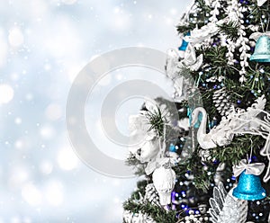 Christmas tree background and Christmas decorations with snow, blurred, sparking, glowing.