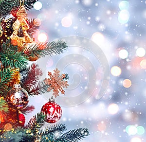 Christmas tree background and Christmas decorations with snow, blurred, sparking, glowing. Happy New Year and Xmas