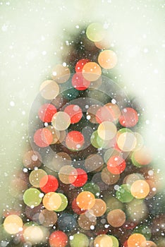 Christmas tree background with snowfall and bokeh lights