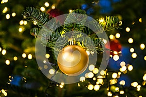 Christmas Tree Ball Ornament Festive Holiday Decoration Gold Closeup Depth of Field Bokeh Centered