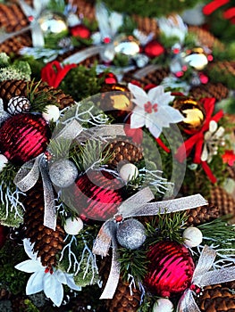 Christmas tree  balls and  Pine cones  on  tree fir branches, red ,green ,blue colored decoration and white snowflakes  ,  holiday