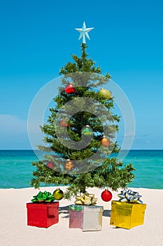 Christmas Tree on the beach. Merry Christmas. Present gift box. Happy New Year. Winter Holidays. Miami Florida vacation.