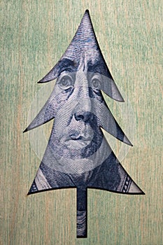 Christmas tree with benjamin franklin`s face with one hundred dollar bill