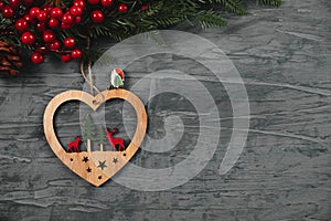 Christmas tree,berries and wooden heart with grey back ground