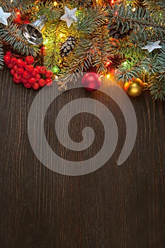 Christmas tree with berry and decorations on wooden background