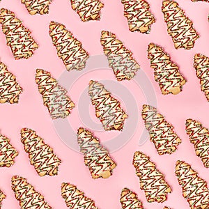 Christmas tree biscuits on pink background.