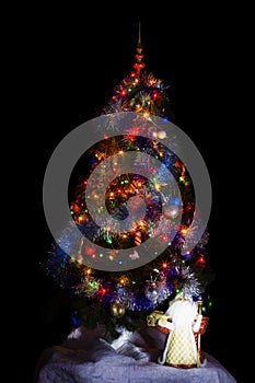 Christmas tree on the black background