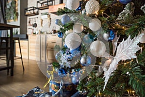 Christmas tree with blue and white toys in the interior, Christmas card with white and blue decor.Winter holidays. home