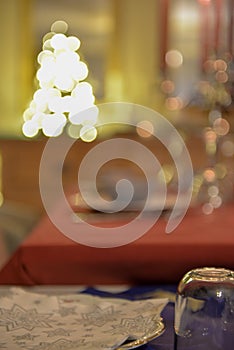 Christmas tree with bokeh lights and ornament against a soft background