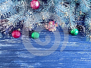 Christmas tree branch, ball on decorative celebration wooden background