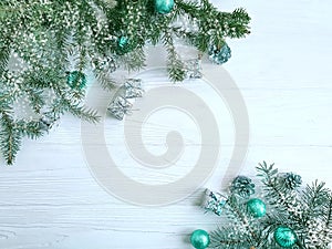 Christmas tree branch, ball, gift, border cone traditional on white wooden background