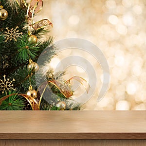 Christmas tree branch behind empty wood table or shelf