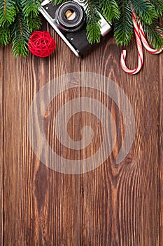 Christmas tree branch, camera and candy cane