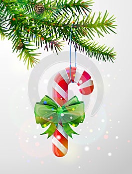 Christmas tree branch with candy cane decorated ribbon