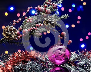 Christmas tree branch with decoration ball. Winter red, silver garland.