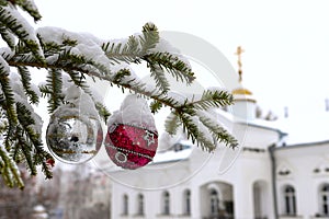 Christmas tree branch with decorations on the background of the Orthodox cross with a crucifix. The Orthodox Church. Winter is Chr