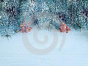 Christmas tree branch festive card border on wooden background, snow