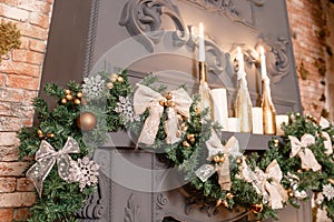 Christmas tree branch on fireplace and other holiday decorations in dark loft