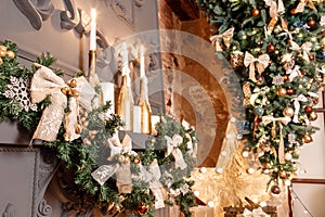 Christmas tree branch on fireplace and other holiday decorations in dark loft