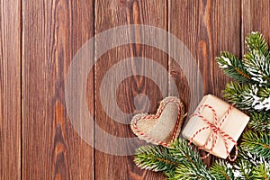 Christmas tree branch with gift box and heart toy