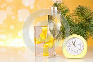 Christmas-tree branch, a glass of champagne, gift box and about twelve hours