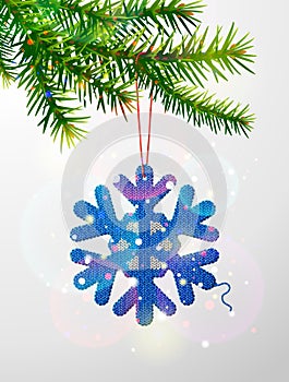 Christmas tree branch with knitted snowflake symbol