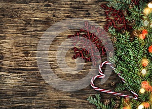 Christmas tree branch with pinecones and Christmas ornament on wooden background, copy space