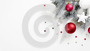 Christmas tree branch with red balls and white decorative stars isolated on white background. Xmas banner mockup wit copy space,