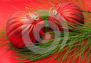 Christmas tree branch with red baubles
