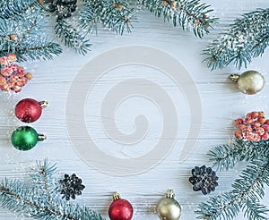 Christmas tree branch, snow celebration on a white wooden background frame